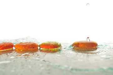 Image showing isolated wet zen stones with splashing  water drops  