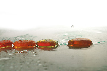 Image showing isolated wet zen stones with splashing  water drops  