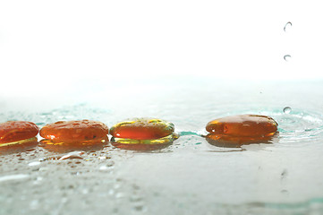 Image showing isolated wet zen stones with splashing  water drops