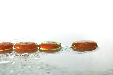 Image showing isolated wet zen stones with splashing  water drops