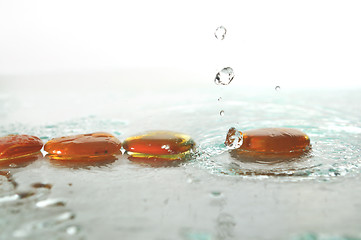 Image showing isolated wet zen stones with splashing  water drops