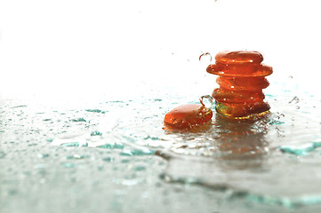 Image showing isolated wet zen stones with splashing  water drops