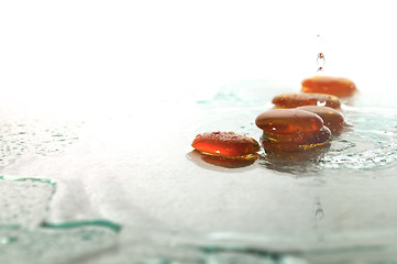 Image showing isolated wet zen stones with splashing  water drops