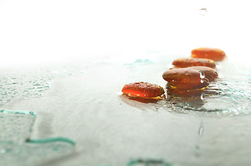 Image showing isolated wet zen stones with splashing  water drops