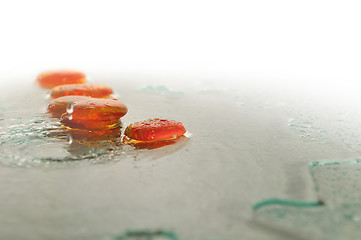 Image showing isolated wet zen stones with splashing  water drops  