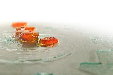 Image showing isolated wet zen stones with splashing  water drops  