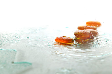 Image showing isolated wet zen stones with splashing  water drops