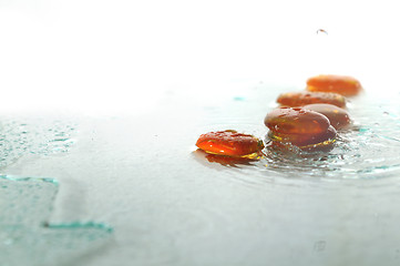 Image showing isolated wet zen stones with splashing  water drops