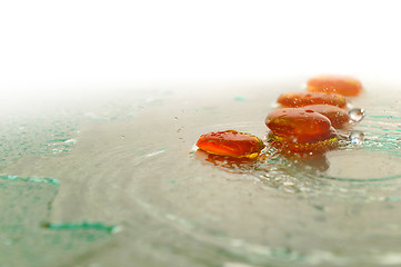 Image showing isolated wet zen stones with splashing  water drops  