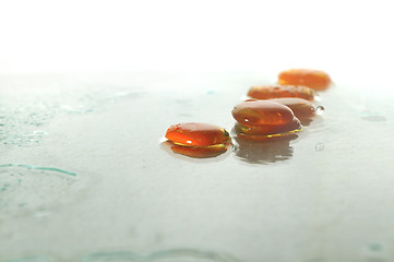 Image showing isolated wet zen stones with splashing  water drops