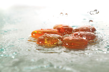 Image showing isolated wet zen stones with splashing  water drops