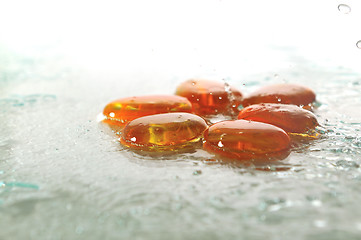 Image showing isolated wet zen stones with splashing  water drops