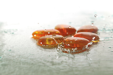 Image showing isolated wet zen stones with splashing  water drops