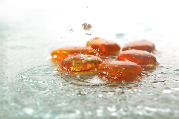 Image showing isolated wet zen stones with splashing  water drops