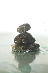 Image showing isolated wet zen stones with splashing  water drops