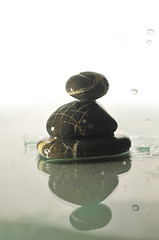 Image showing isolated wet zen stones with splashing  water drops