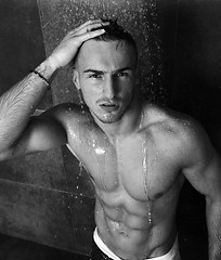 Image showing good looking man under man shower