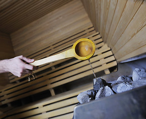 Image showing hot stones and splashing water in sauna