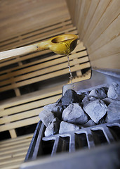 Image showing hot stones and splashing water in sauna