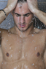 Image showing good looking man under man shower