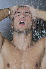 Image showing good looking man under man shower