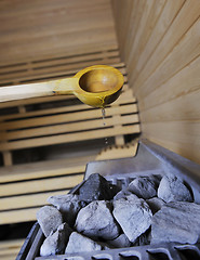 Image showing hot stones and splashing water in sauna