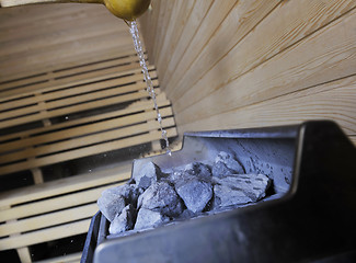 Image showing hot stones and splashing water in sauna