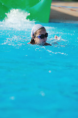 Image showing girl have fun  on water slide at outdoor swimming pool