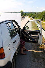 Image showing Young woman waiting in car