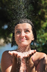 Image showing beautiful woman washing and cleaning face under shower