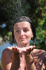 Image showing beautiful woman washing and cleaning face under shower