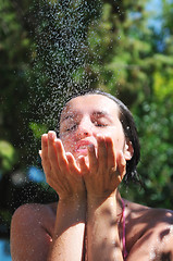 Image showing beautiful woman washing and cleaning face under shower