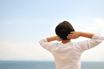 Image showing Young pretty woman enjoying the sun