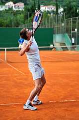 Image showing Man plays tennis outdoors