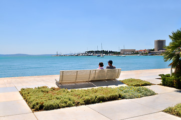 Image showing Happy young couple sitting on the beach