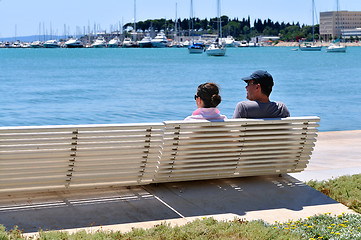 Image showing Happy young couple sitting on the beach