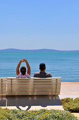 Image showing Happy young couple sitting on the beach