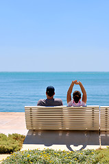Image showing Happy young couple sitting on the beach