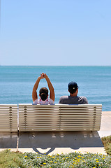 Image showing Happy young couple sitting on the beach