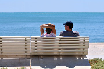 Image showing Happy young couple sitting on the beach