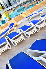 Image showing Empty chairs by the pool of  hotel