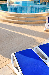 Image showing Empty chairs by the pool of  hotel