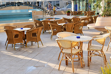 Image showing Wooden forniture by the pool of hotel