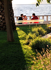 Image showing Happy family watching sunset on the beach