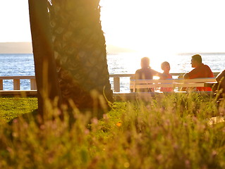 Image showing Happy family watching sunset on the beach