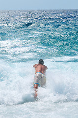 Image showing man jumping in sea