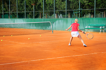 Image showing Girl playing tennis outdoor