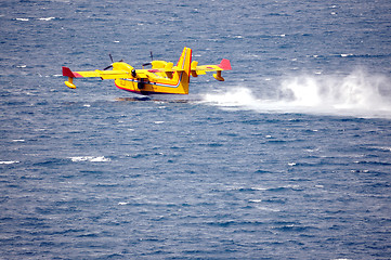 Image showing Airplane on sea taking water