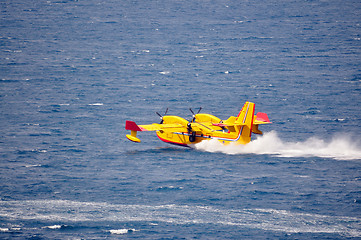 Image showing Airplane on sea taking water