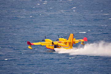 Image showing Airplane on sea taking water